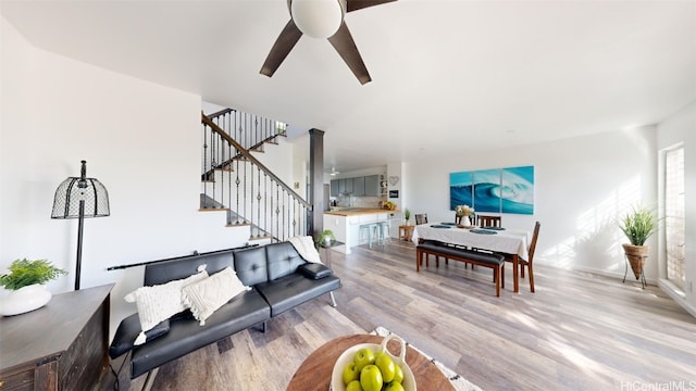 living room featuring light wood-type flooring and ceiling fan