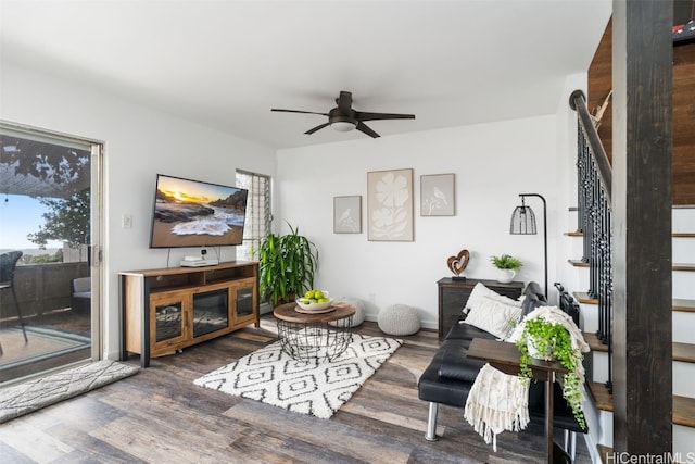 living room with ceiling fan and dark hardwood / wood-style flooring