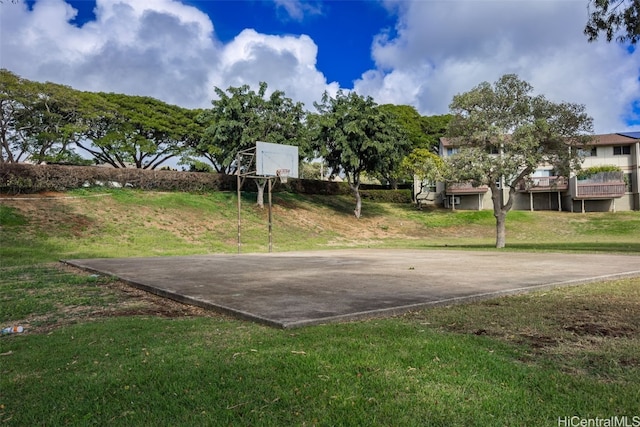 view of sport court featuring a lawn