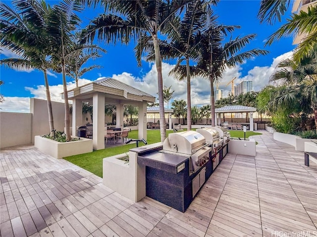 deck featuring a gazebo, a patio, area for grilling, and a grill