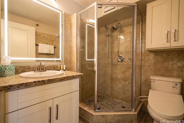 bathroom featuring walk in shower, vanity, and toilet