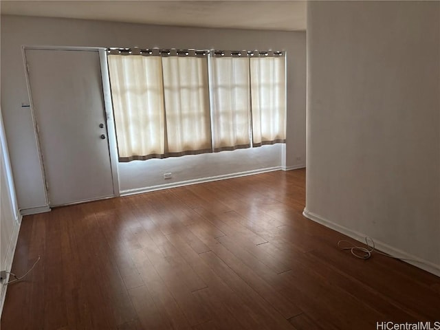 spare room with dark hardwood / wood-style flooring