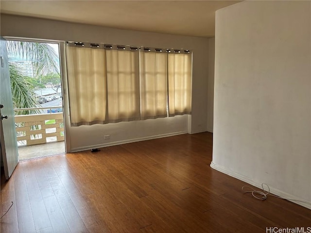 unfurnished room with wood-type flooring