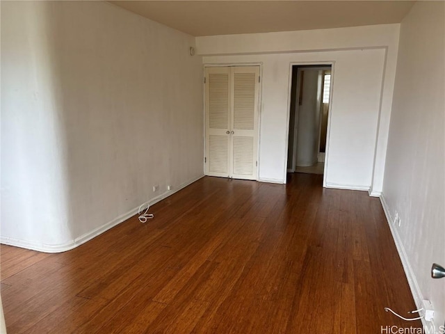 unfurnished bedroom featuring dark wood-type flooring