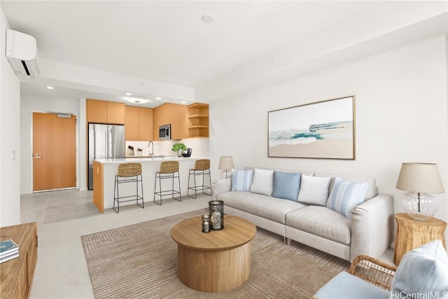 living room with sink and an AC wall unit