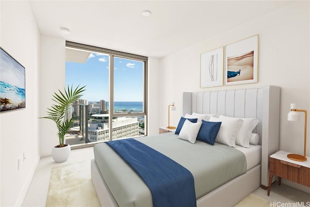 bedroom featuring light carpet, access to exterior, a water view, and expansive windows