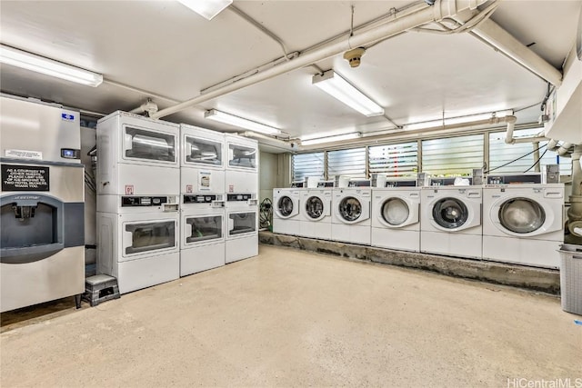 laundry room featuring stacked washer and dryer and washing machine and clothes dryer