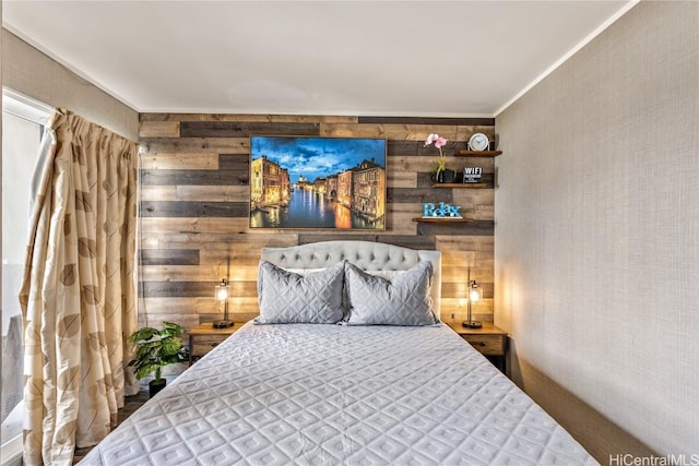 bedroom with wooden walls and crown molding