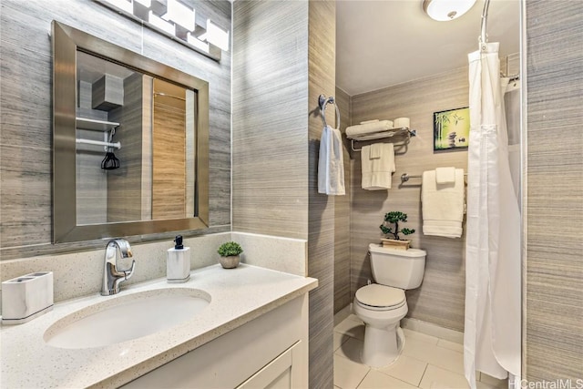 bathroom featuring tile patterned flooring, vanity, and toilet