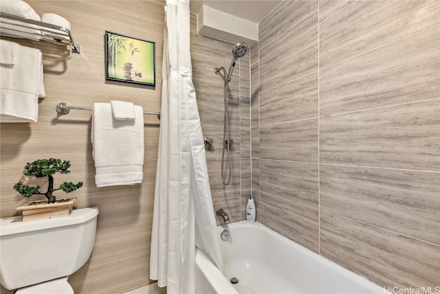 bathroom with toilet and shower / tub combo with curtain