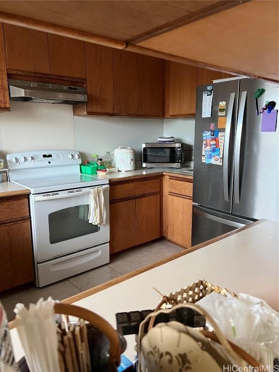 kitchen with light tile patterned floors and appliances with stainless steel finishes