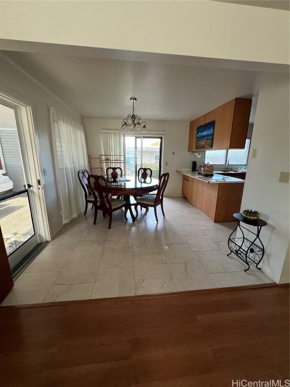 dining room with an inviting chandelier and light tile patterned floors