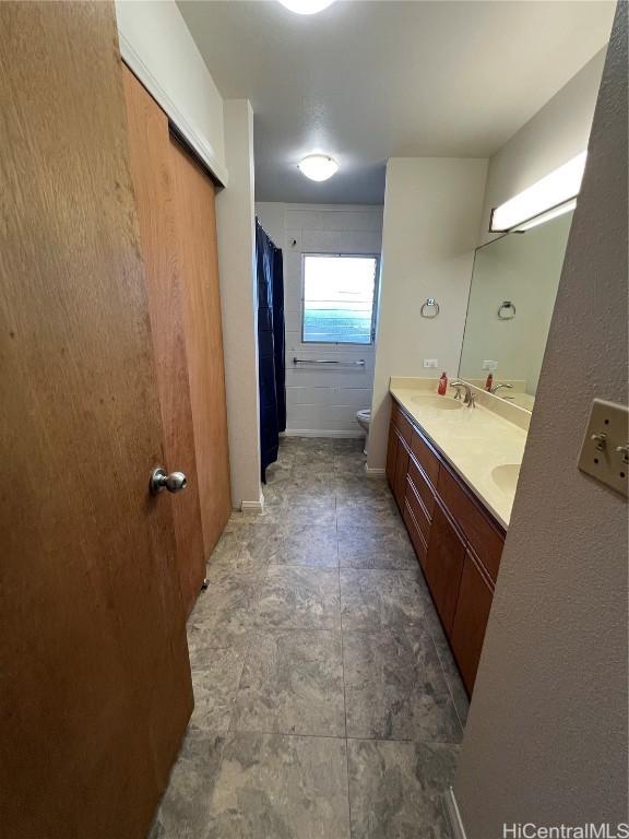 bathroom featuring toilet and vanity