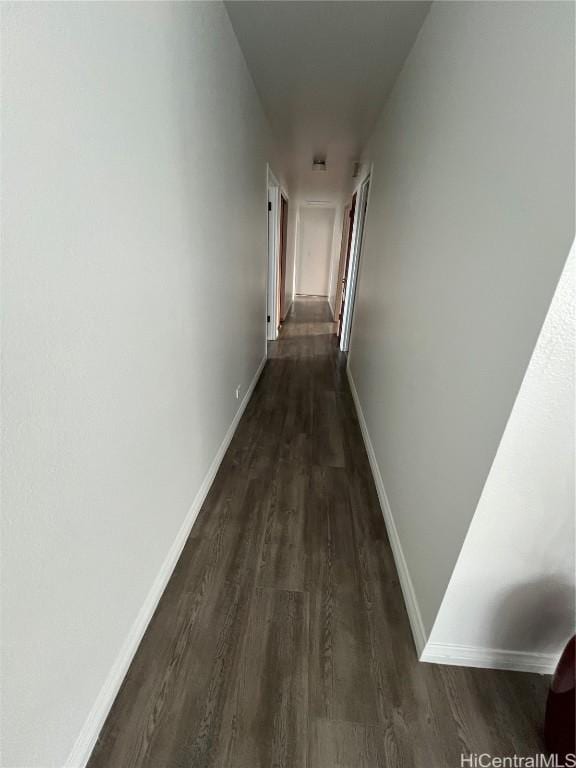 hallway with dark hardwood / wood-style floors