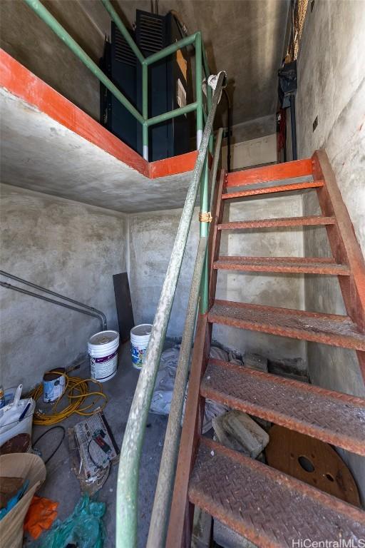 staircase with concrete flooring