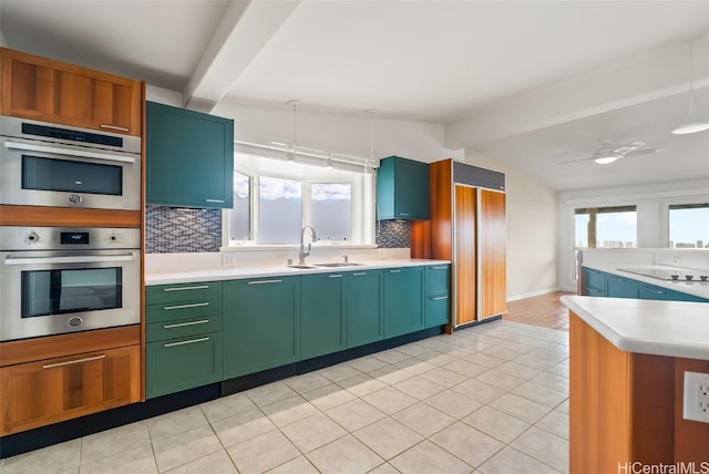 kitchen with sink, vaulted ceiling with beams, stainless steel double oven, and backsplash