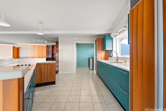 kitchen with decorative light fixtures, light tile patterned floors, and sink