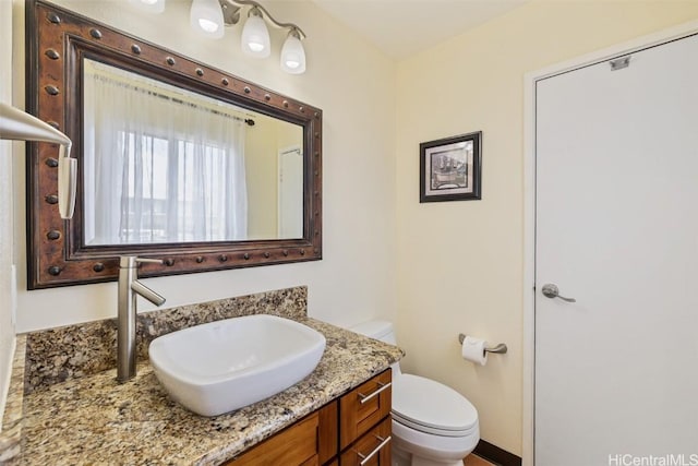 bathroom with toilet and vanity