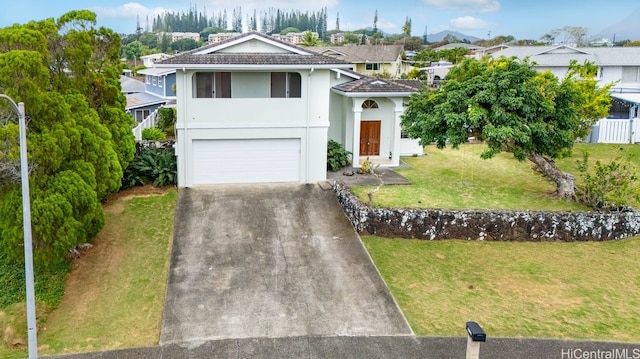 view of front of property featuring a front yard and a garage