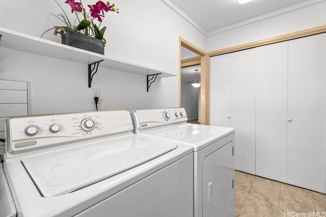 laundry area featuring washer and dryer and ornamental molding