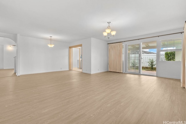 46-145 Humu Pl, Kaneohe, HI 96744 - unfurnished room featuring a chandelier, baseboards, light wood finished floors, and arched walkways