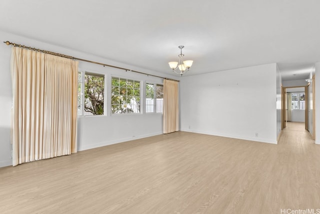 46-145 Humu Pl, Kaneohe, HI 96744 - spare room featuring a chandelier, light wood-style floors, and baseboards