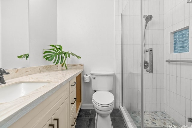 bathroom with tile patterned flooring, vanity, an enclosed shower, and toilet