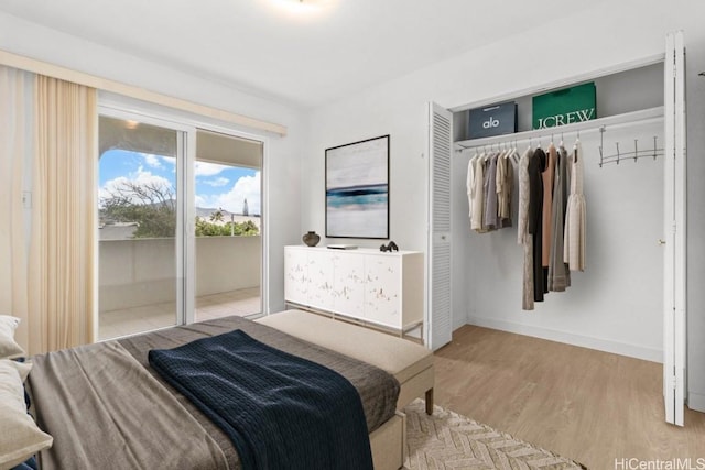 bedroom with light wood-type flooring and access to outside