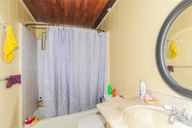 full bathroom featuring toilet, wooden walls, vanity, wood ceiling, and shower / tub combo