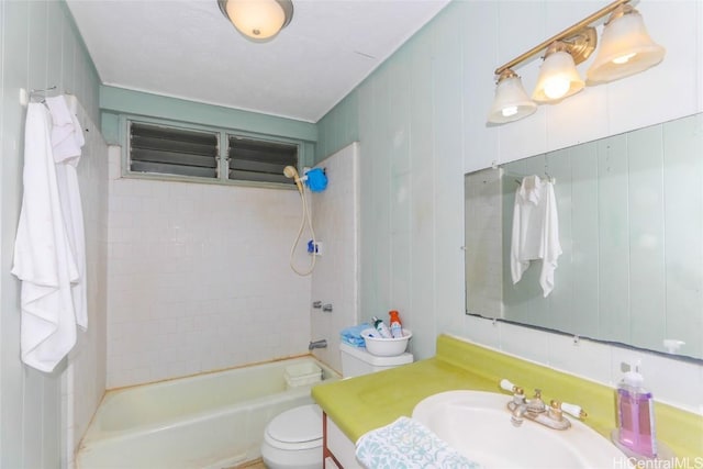 full bathroom with vanity, tiled shower / bath combo, and toilet