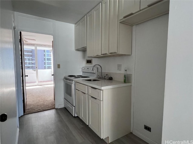 kitchen with white cabinets, sink, dark wood-type flooring, and electric stove