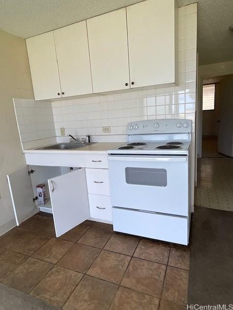 kitchen featuring white range with electric cooktop, backsplash, white cabinets, and sink