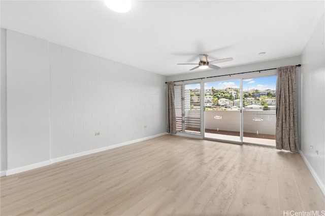 empty room with ceiling fan and light hardwood / wood-style floors