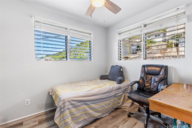 bedroom featuring baseboards, a ceiling fan, and wood finished floors