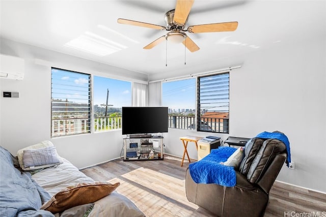 living area with light wood-type flooring, a wall mounted air conditioner, and a healthy amount of sunlight