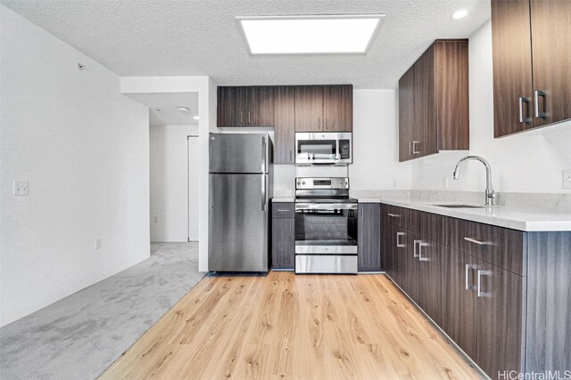 615 Keawe St Unit 406, Honolulu, HI 96813 - kitchen featuring sink, stainless steel appliances, light hardwood / wood-style flooring, and a textured ceiling