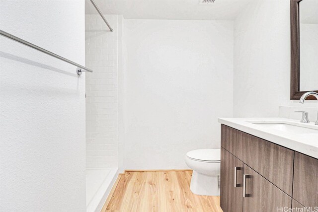 615 Keawe St Unit 406, Honolulu, HI 96813 - bathroom with wood-type flooring, walk in shower, vanity, and toilet