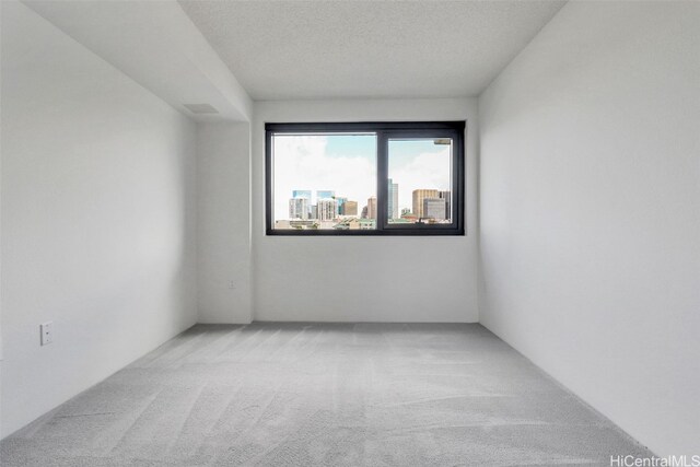 615 Keawe St Unit 406, Honolulu, HI 96813 - carpeted spare room featuring a textured ceiling