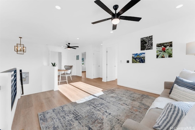 living room featuring light hardwood / wood-style flooring and ceiling fan