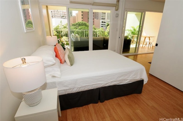 bedroom featuring access to outside and wood-type flooring