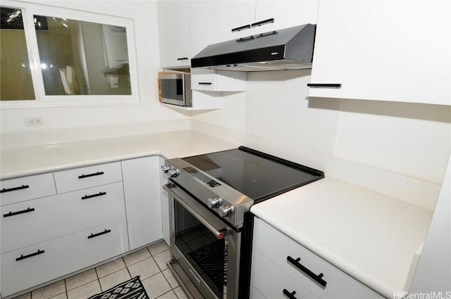 kitchen with white cabinetry, light tile patterned floors, and appliances with stainless steel finishes