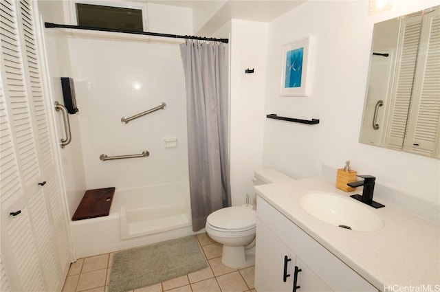 bathroom with tile patterned flooring, vanity, and toilet