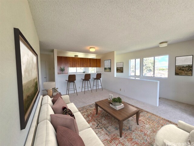 living room with a textured ceiling and light carpet