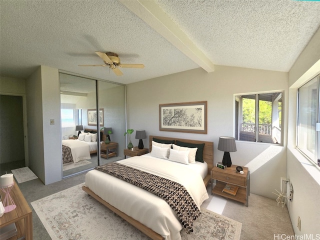 bedroom featuring a textured ceiling, ceiling fan, a closet, and vaulted ceiling with beams