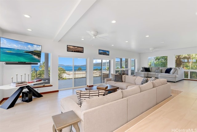 living room featuring ceiling fan, beamed ceiling, and a water view