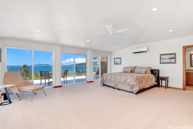 bedroom featuring a wall mounted air conditioner, access to exterior, vaulted ceiling, ceiling fan, and a water view