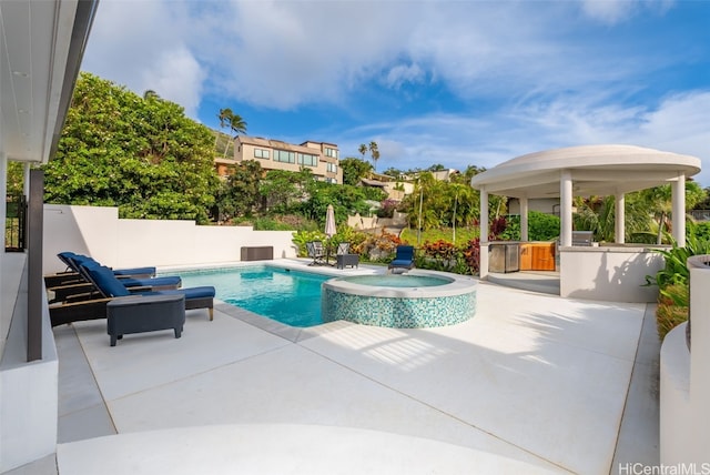 view of swimming pool with a gazebo, a patio area, and an in ground hot tub