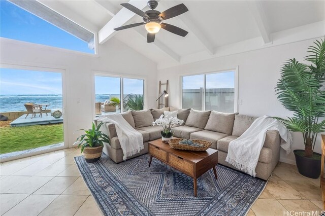 interior space featuring light tile patterned flooring, a water view, ceiling fan, a wealth of natural light, and beam ceiling