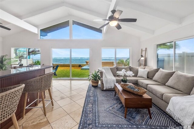 sunroom with ceiling fan, a water view, and lofted ceiling with beams