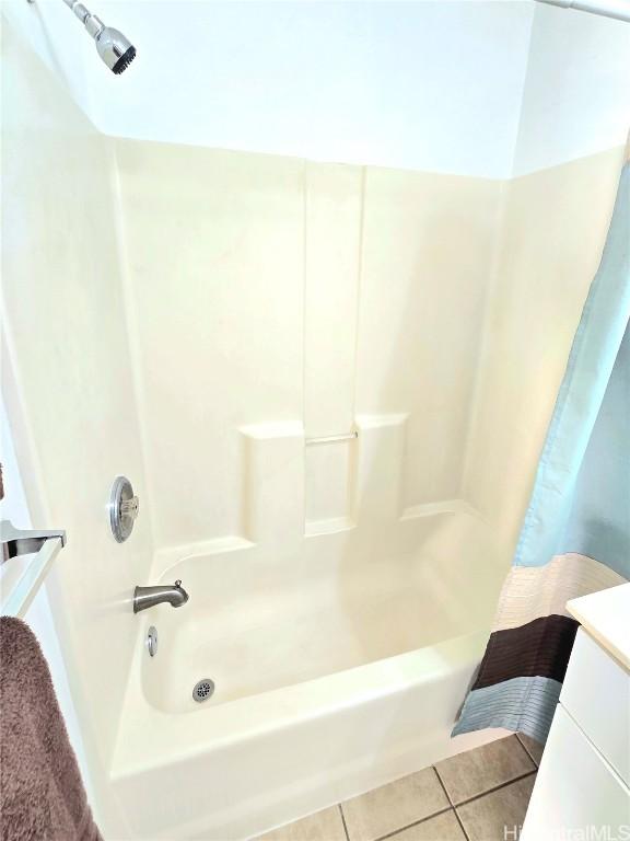 bathroom featuring tile patterned floors and shower / bathtub combination with curtain